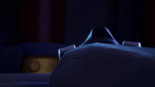 a cartoon character with blue eyes and a black cape