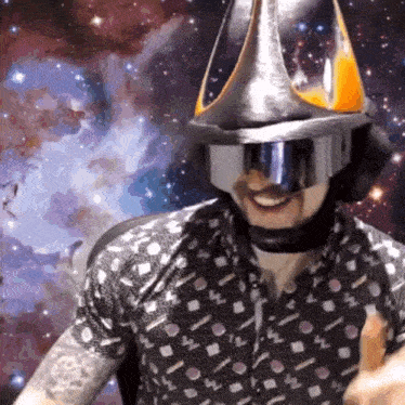 a man wearing a helmet and goggles giving a thumbs up