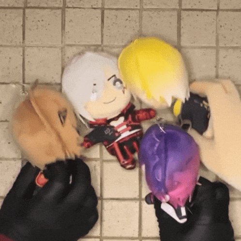 a person is holding a stuffed toy that has a yellow hair