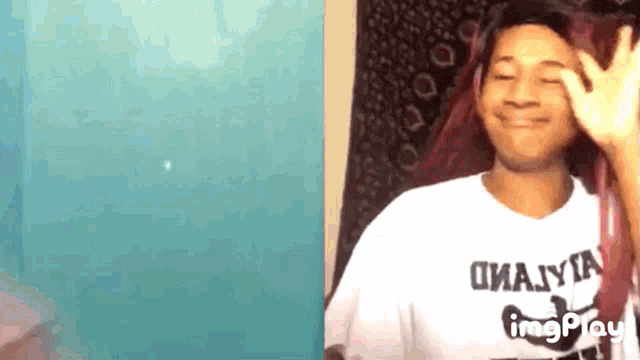 a man wearing a white t-shirt that says omaiya on it