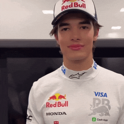 a young man wears a red bull hat and a white shirt