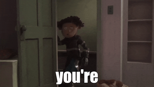 a cartoon character is standing in a room with the word crazy written on it .
