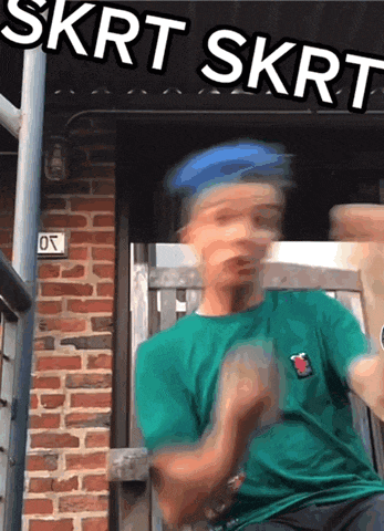 a blurry picture of a man wearing a green shirt with skrt skrt written on it