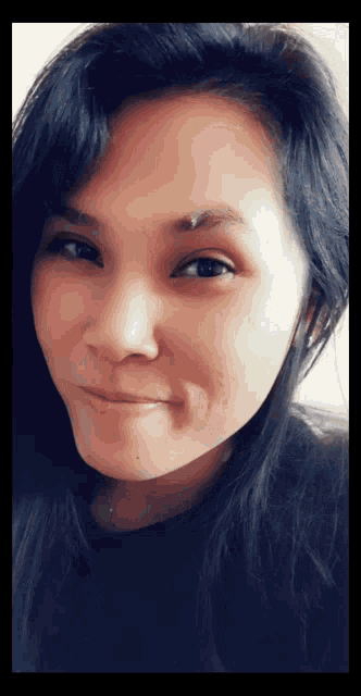 a close up of a woman 's face with a nose ring
