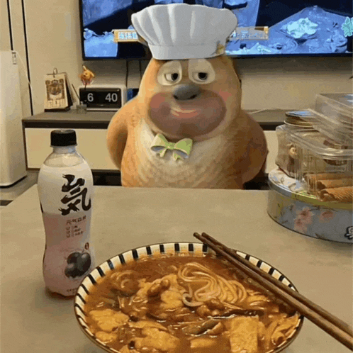a cartoon bear wearing a chef hat sits at a table next to a bowl of food