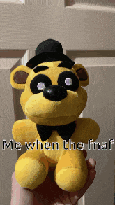 a person is holding a stuffed bear that says me when the fnaf on it