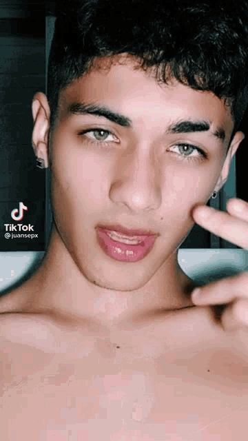 a close up of a young man 's face with a tik tok watermark