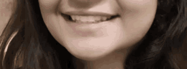 a close up of a woman 's mouth with a smile on it .
