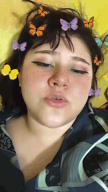 a girl with butterflies in her hair is laying on a bed