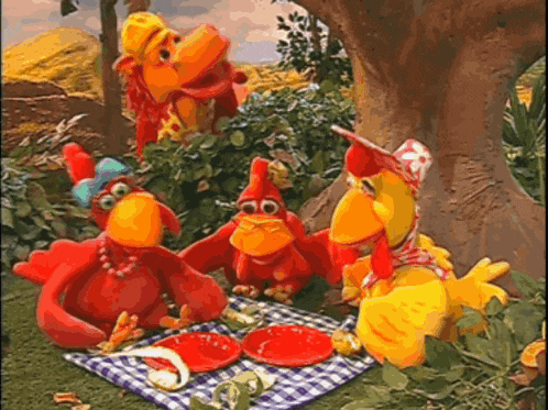 a group of stuffed chickens are having a picnic together