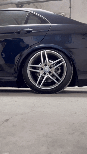 a close up of a car wheel with a mercedes logo