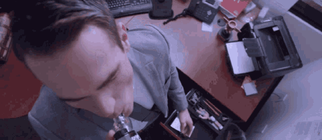 a man in a suit is smoking a cigarette