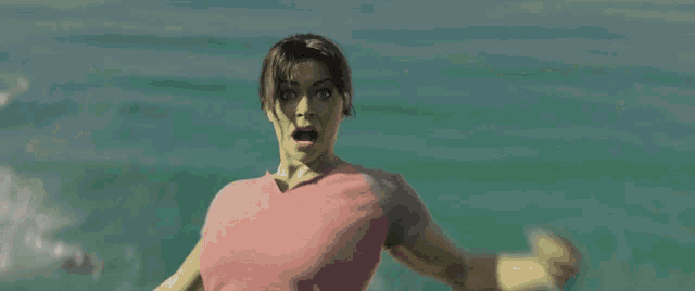 a person giving the middle finger while riding a wave in the ocean