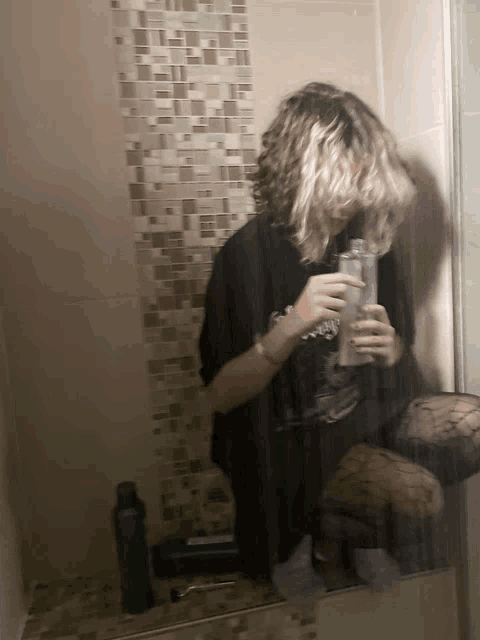 a person is taking a picture of themselves in a bathroom mirror