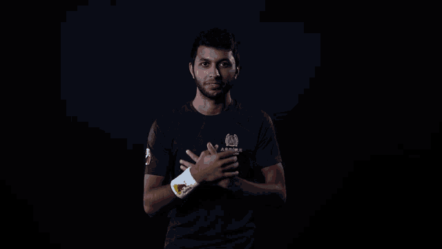 a man wearing a blue shirt with a red bull logo on it