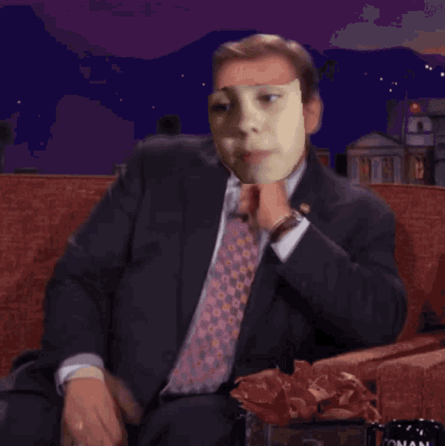 a man in a suit and tie has a face on his face