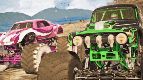 a green monster truck is driving next to a pink and white monster truck