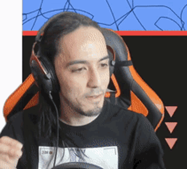 a man with long hair wearing headphones and a black shirt