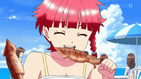a girl with red hair is eating a squid on a stick