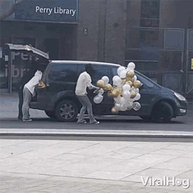 a perry library sign is above a car