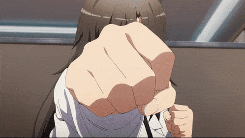 a close up of a person 's fist with a white shirt on