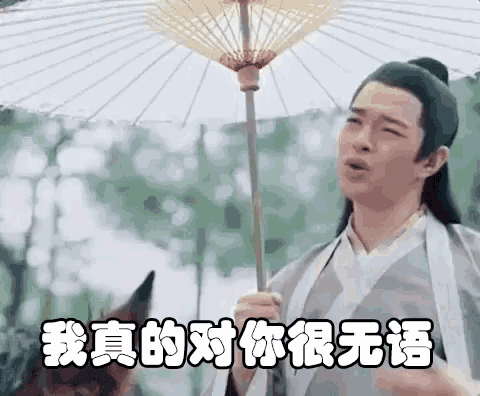 a man in a kimono is holding an umbrella and making a face .