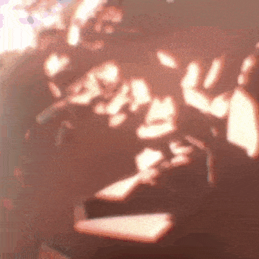 a blurry picture of a person 's face with a lot of shadows on it .