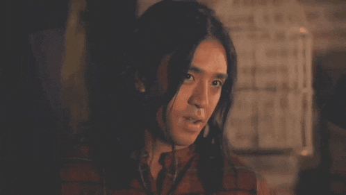 a man with long hair is smiling and says " isang malaking kalokohan "