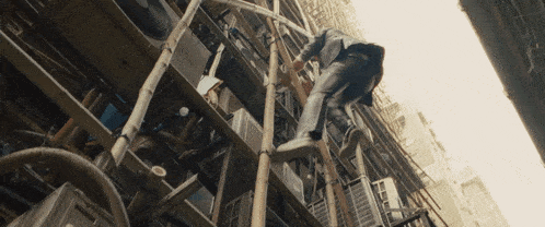 a man in a suit is climbing a ladder in a building