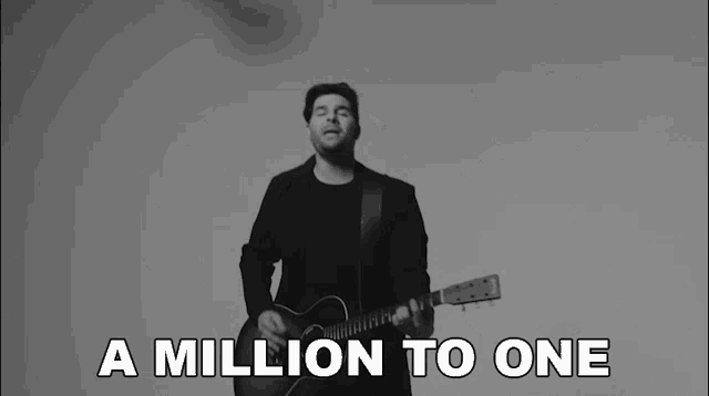 a black and white photo of a man singing and playing a guitar with the words a million to one below him