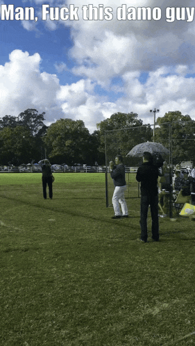 a group of people standing in a field with the words man fuck this damo guy