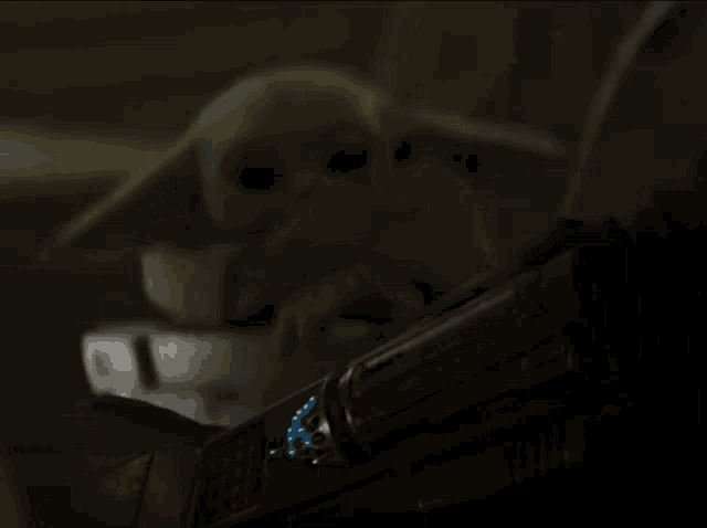 a close up of a helmet with a blue glowing r on it