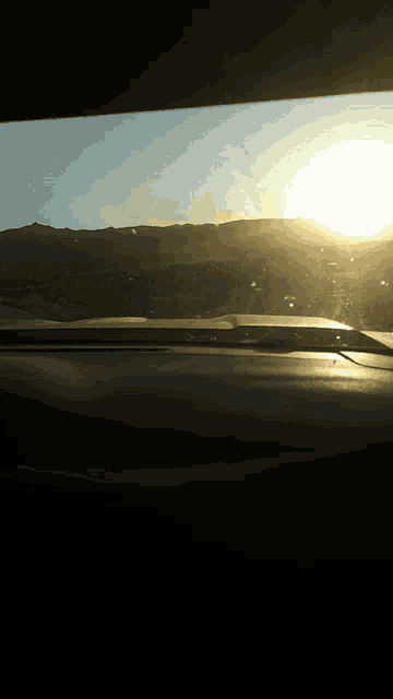 the sun is shining through the windshield of a vehicle