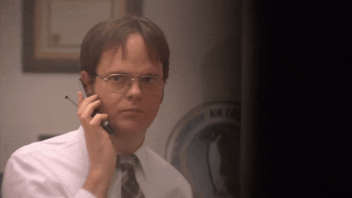 a man wearing glasses is talking on a cellphone