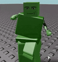 a green lego man is standing on top of a grid of squares .
