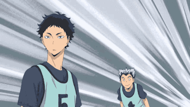 a man with the number 5 on his shirt is standing next to another man