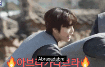 a man wearing a vest with the word abracadabra on it