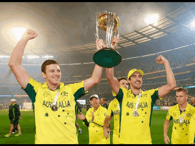 a group of men holding up a trophy that says australia on their shirts