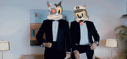 two men in tuxedos with cartoon cats on their faces standing next to each other
