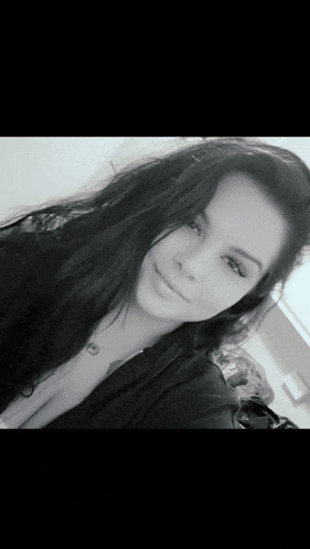 a black and white photo of a girl with long hair
