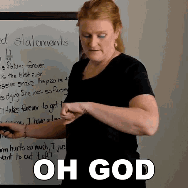 a woman stands in front of a white board with oh god written on the bottom