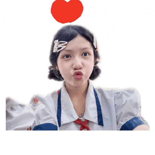 a girl making a funny face with a heart above her head