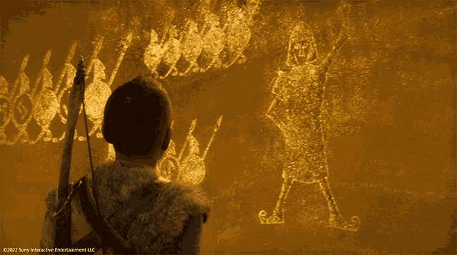 a man with a spear looks at a drawing that says sony interactive entertainment llc on it