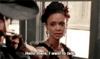 a woman is talking to a man with a gun and saying `` hello there , i want to talk . ''