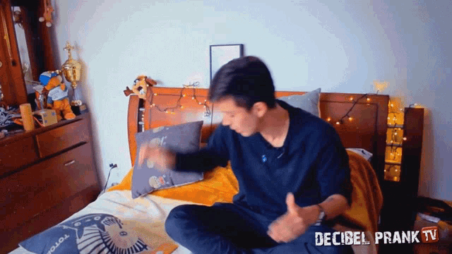 a man sits on a bed with the words decibel prank tv written on the bottom