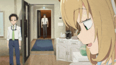 a man and a woman are standing in a hallway with a girl looking at them