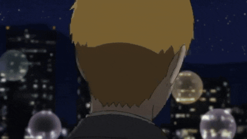 a man with blonde hair is looking at a city at night .