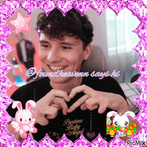 a picture of a man making a heart shape with his hands and the words precious baby angel on the bottom