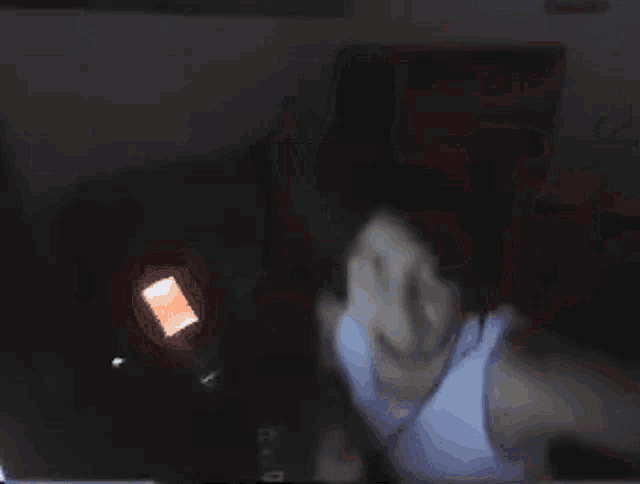a blurry picture of a person 's face with a red square in the corner