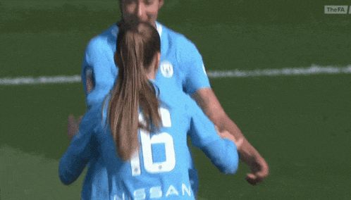a female soccer player wearing a number 6 jersey is hugging another player